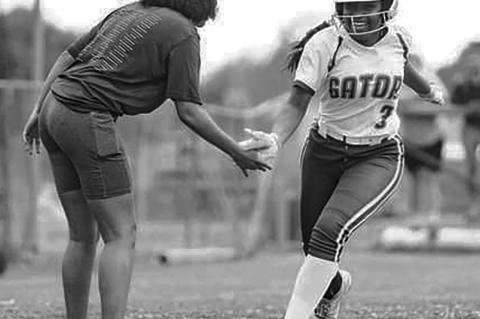 False River’s Maliyah Stewart is congratulated by coach Christina Mayer after hitting a home run against Port Allen in the last game of the season. False River won 17-8. Jarreau Photography